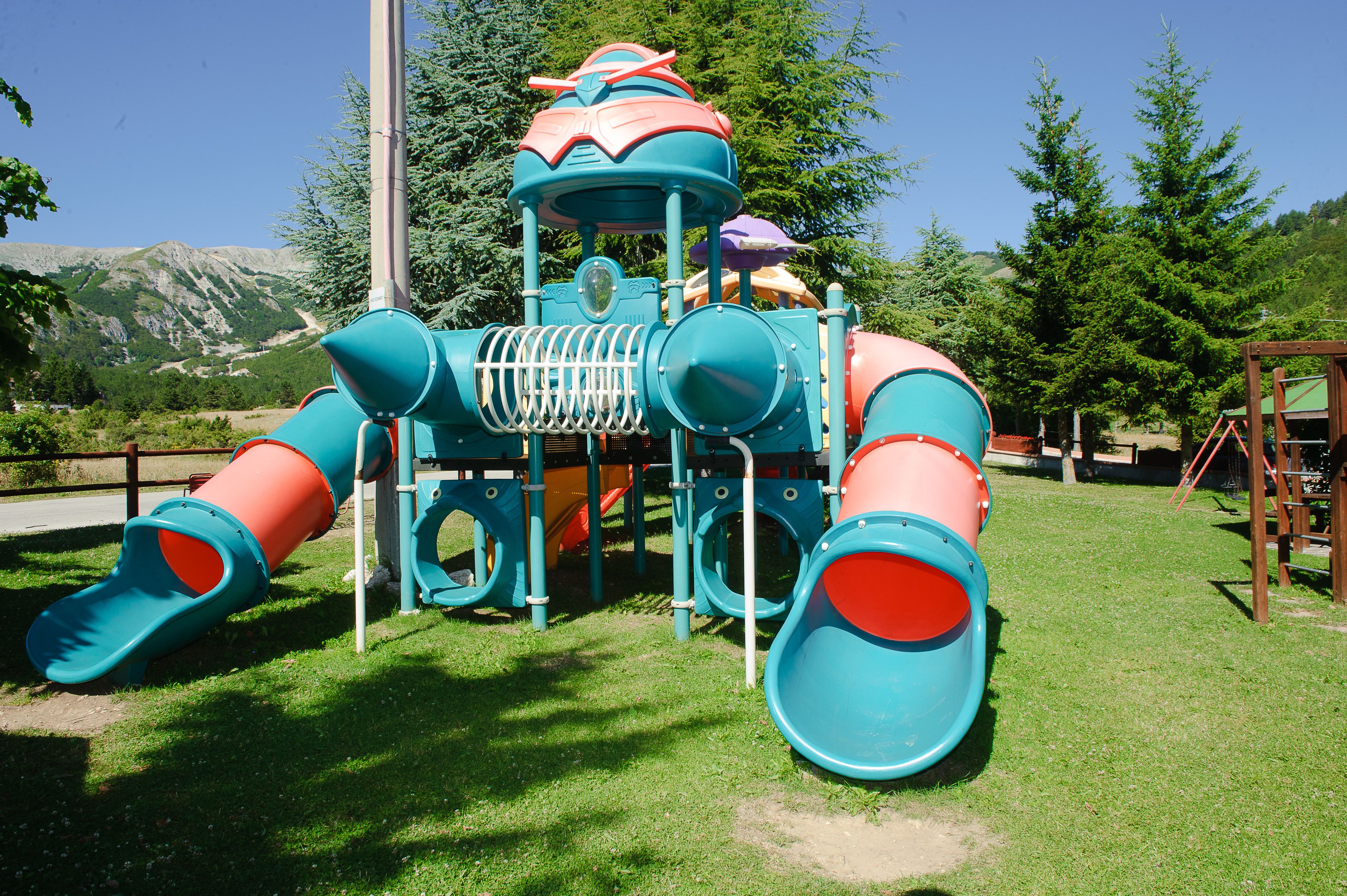 Ein Spielplatz mit Rutschen und Klettergeräten.