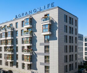A multi-story hotel building with balconies, large windows, and a clear sky. - Grano Life*** Gdańsk (Gdansk)