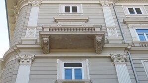 A building with classical architectural details, including columns, a balcony with balustrades, and multiple windows. - Palazzo Talenti 1907 (Trieste)