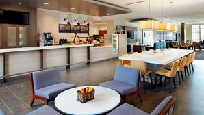 A modern hotel lobby with a bar area, seating arrangements, and a television screen. - Courtyard by Marriott Charlotte Fort Mill, SC (Fort Mill)