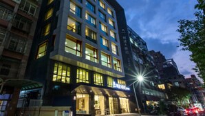 A modern hotel with multiple floors, large windows, and a well-lit facade. - K Hotels Taipei Tianjin (Taipei)