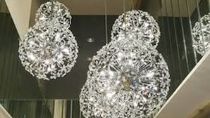 A modern interior with hanging crystal chandeliers and a geometric ceiling design. - K Hotels Taipei Tianjin (Taipei)