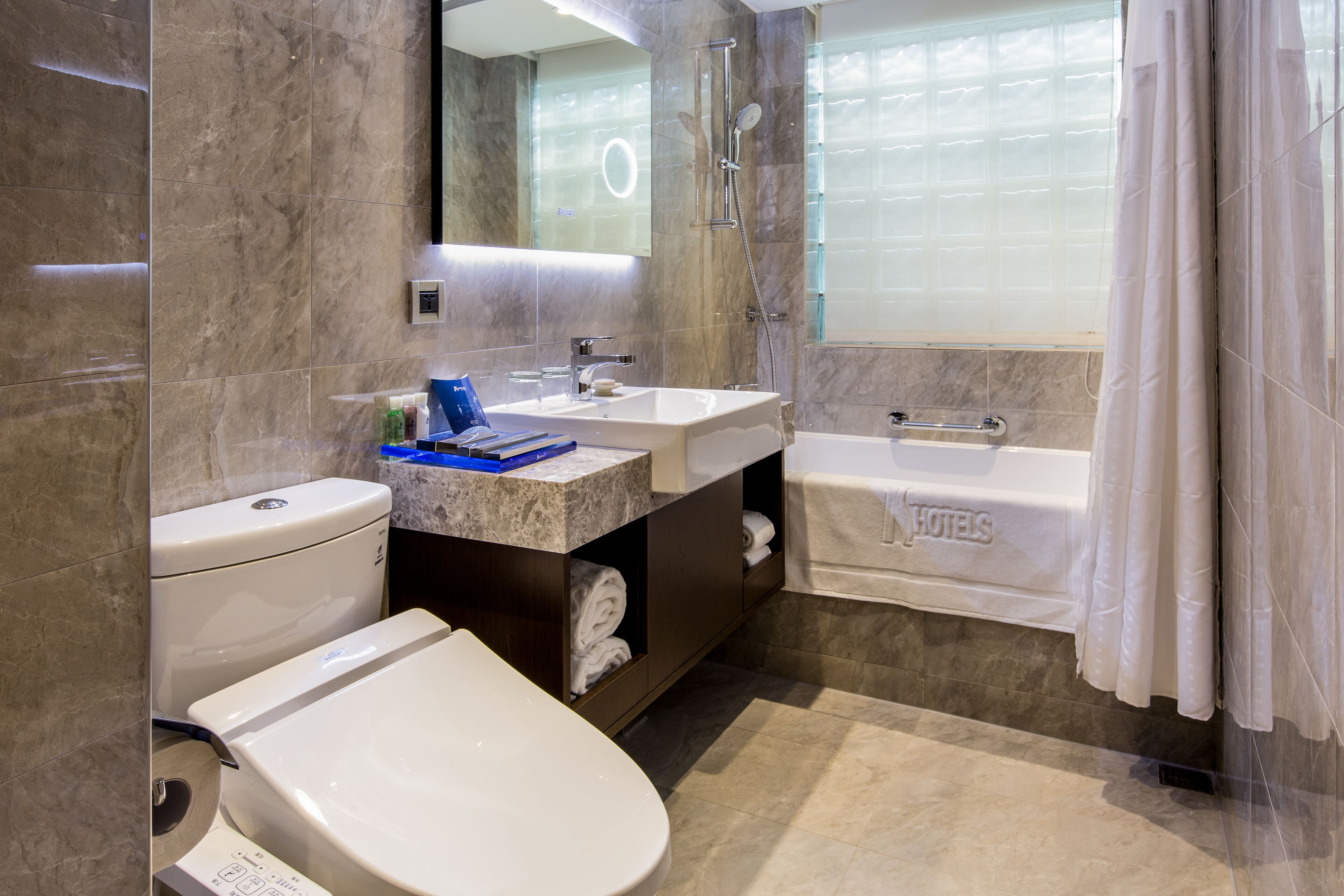 hair dryer, slippers, bidet, towels