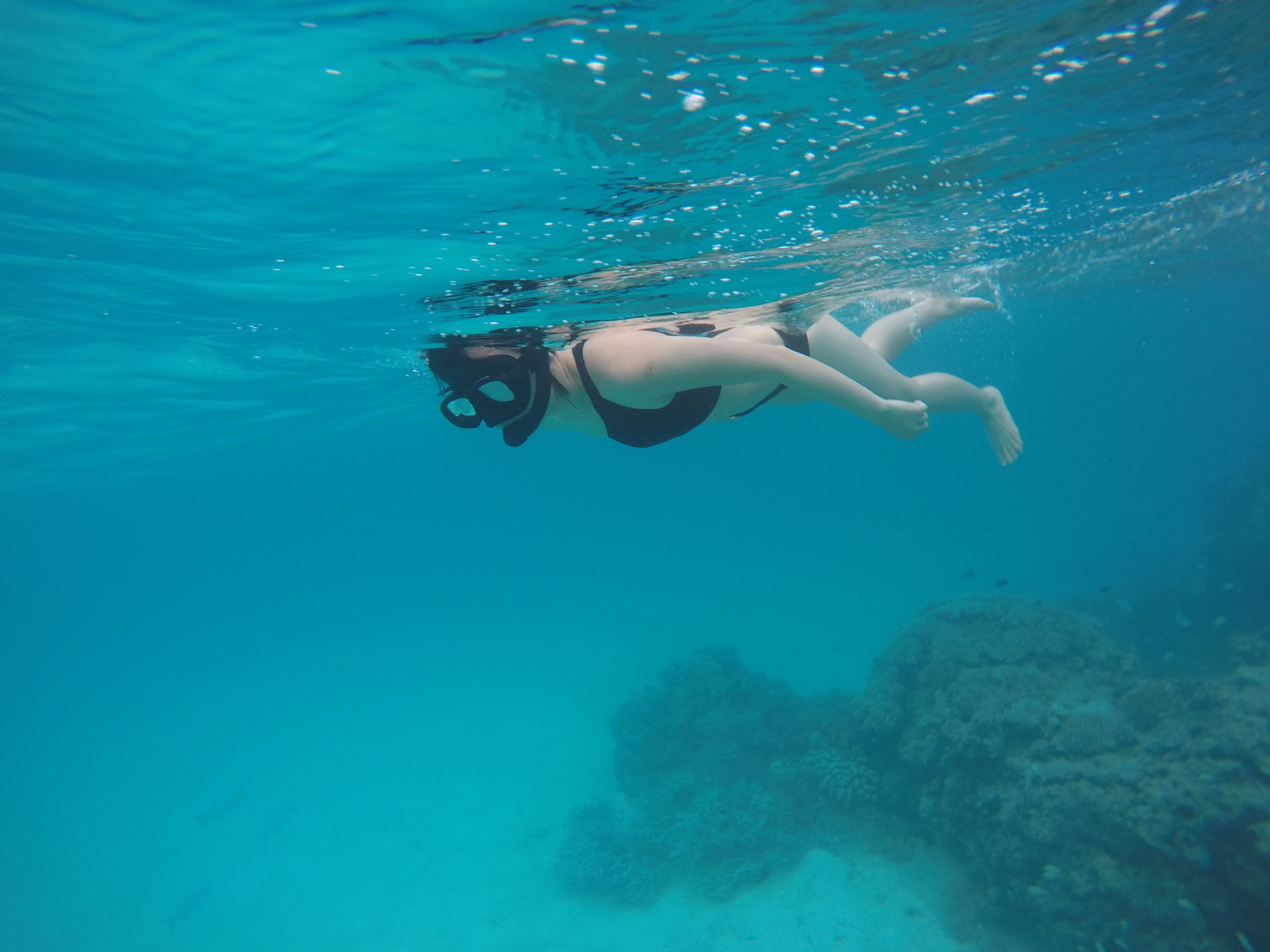 A person swimming underwater.