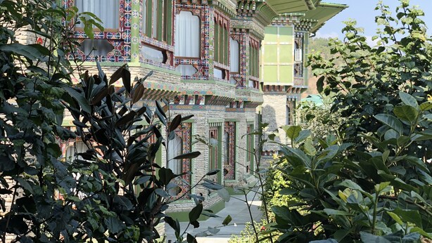 A traditional building with ornate architectural details, including colorful patterns and a tiered roof structure.