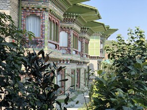A traditional building with ornate architectural details, including colorful patterns and a tiered roof structure. - RKPO Green Resort (Punakha)