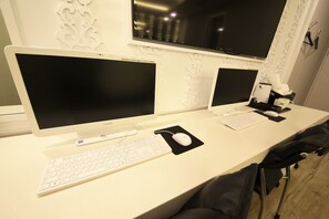 A clean, modern workspace with two monitors, a keyboard, and a mouse on a white desk. - Premium AVA Hotel Sasang (Busan)