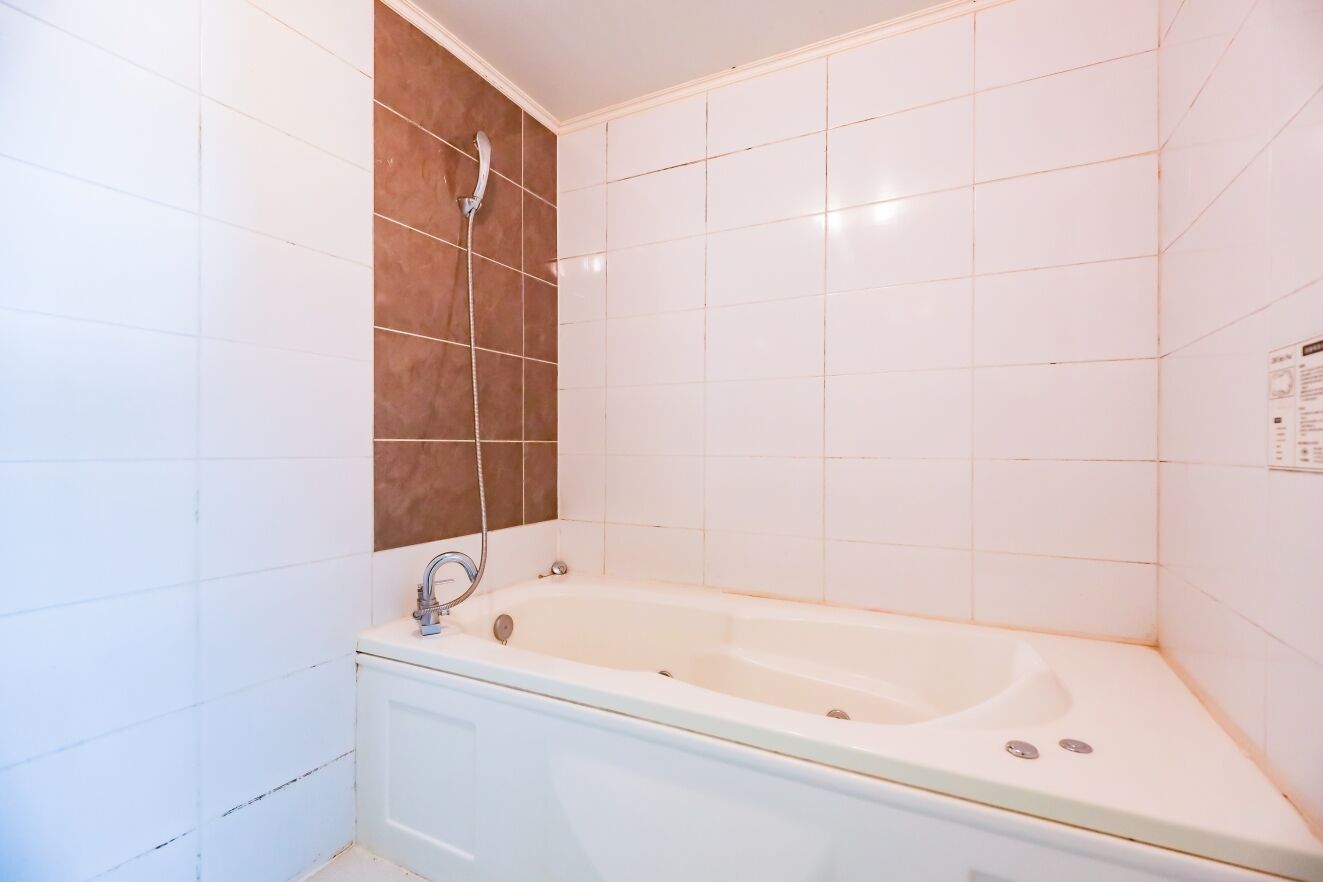 A bathroom with a bathtub, a shower, and a sink.