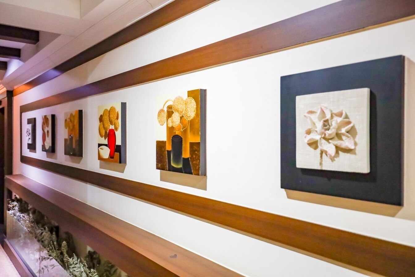 A gallery wall with various framed artworks.