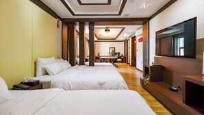 A hotel room with two beds, a TV, a desk, and a bathroom in the background. - Charlot Castle Hotel (Pyeongtaek)