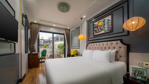 A hotel room with a large bed, a television, a desk, and a view of the outdoors. - Bella Premier Hotel & Rooftop Skybar (Hanoi)