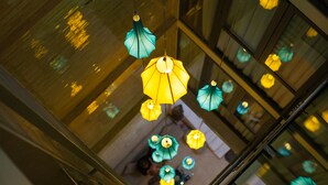 A view of a modern building with multiple hanging lamps. - Bella Premier Hotel & Rooftop Skybar (Hanoi)
