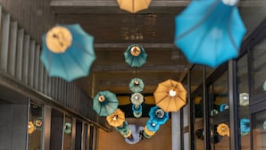 A corridor with hanging paper umbrellas and a wooden ceiling. - Bella Premier Hotel & Rooftop Skybar (Hanoi)