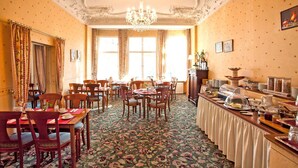 A dining area with ornate ceiling, chandeliers, and floral carpet. - Safestay Berlin Kurfurstendamm (Berlin)