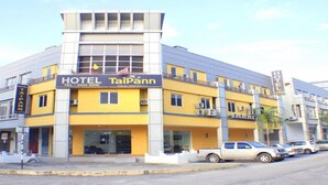 A hotel named 'HOTEL TaiPann' with a yellow facade, a visible entrance, and a signboard with the hotel's name and contact number. - Taipann Hotel (Klang)