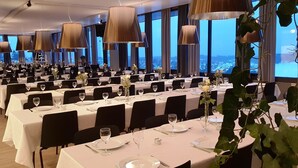 A large dining hall with multiple tables set for a formal event, featuring white tablecloths, wine glasses, and floral centerpieces. - Oslo Hostel Rønningen (Oslo)