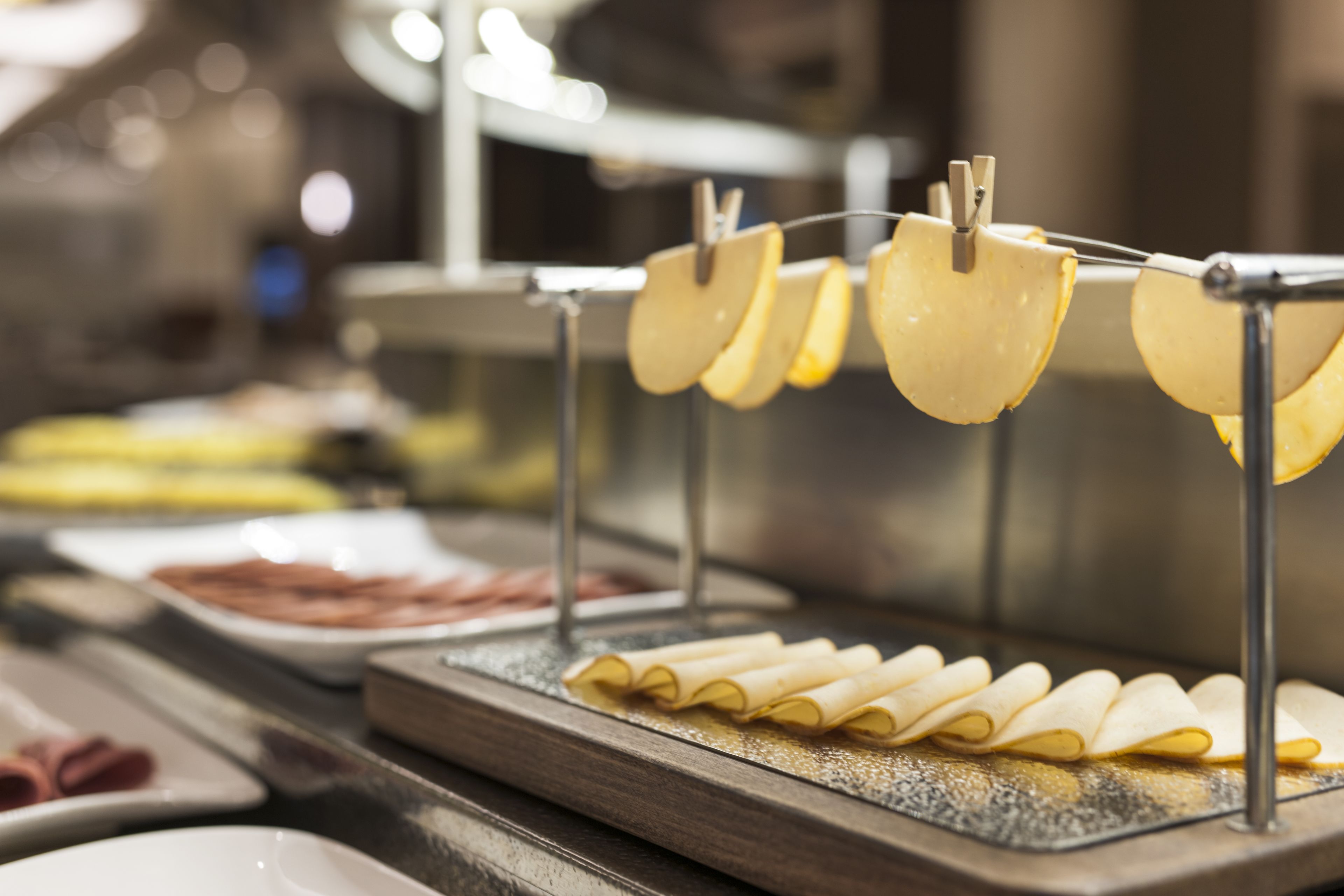 A buffet with various food items, including sliced apples and rolled pastries.