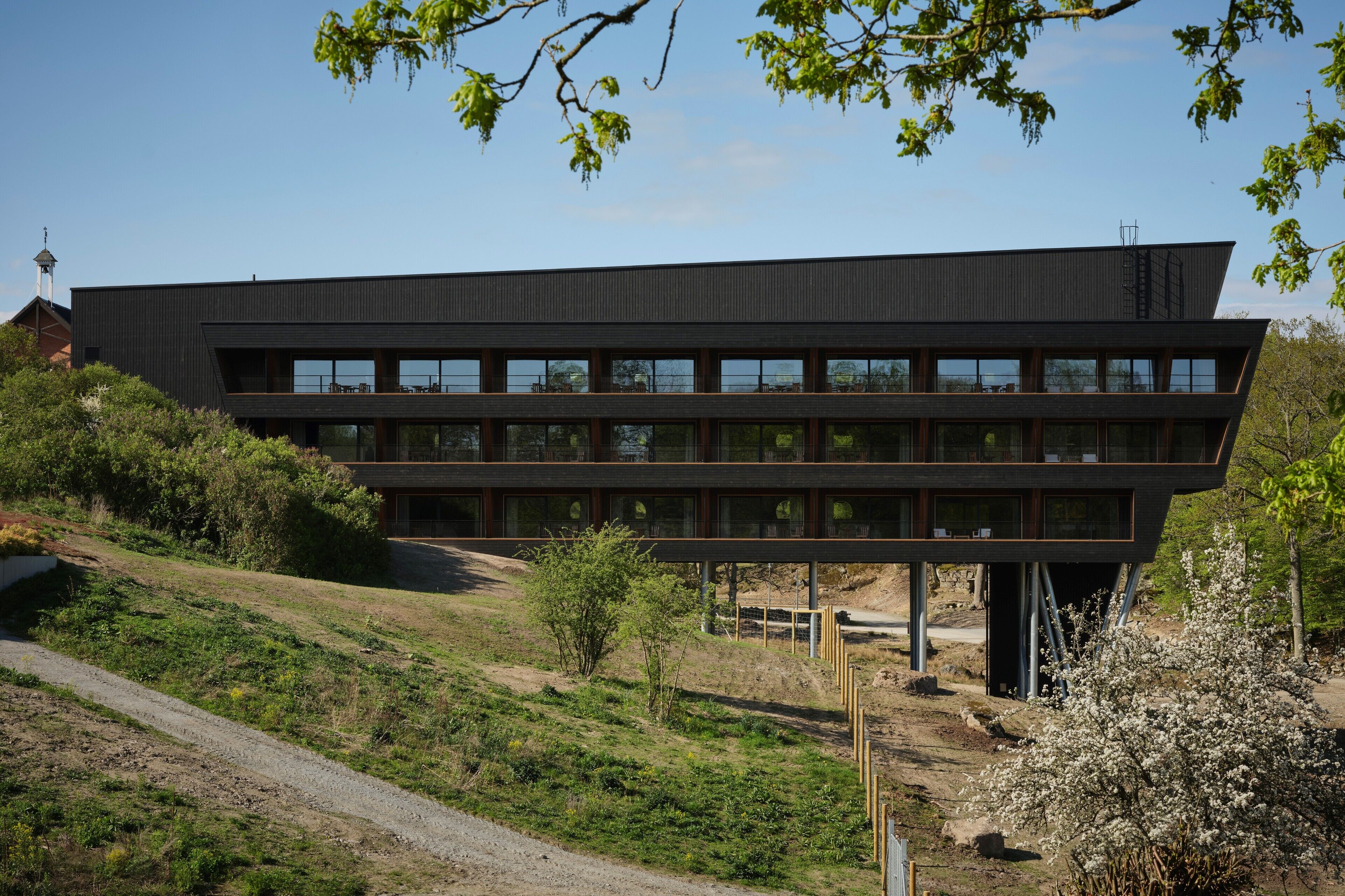 A modern building with a flat roof and a series of windows.
