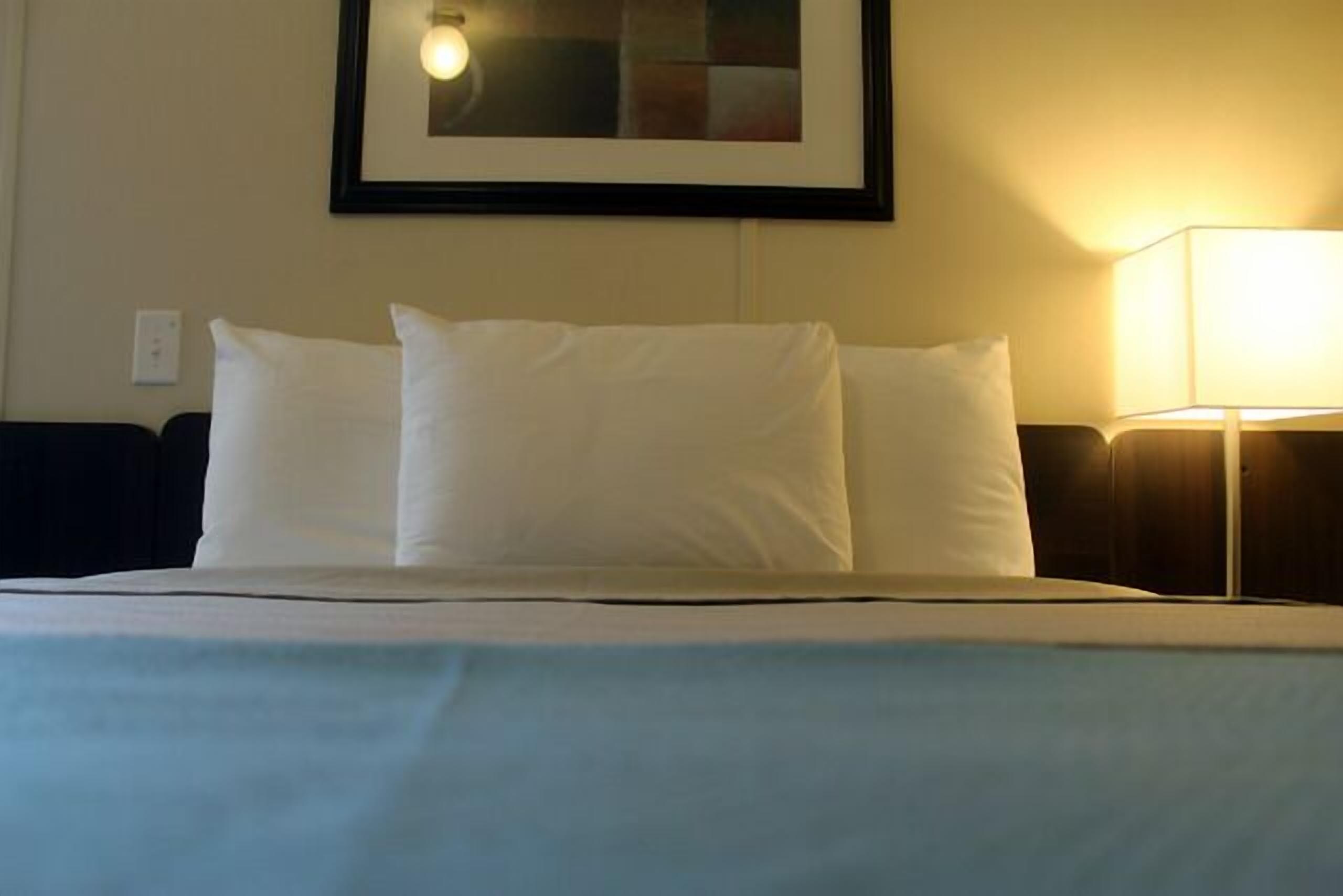 Desk, iron/ironing board, bed sheets