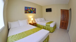 A hotel room with two beds, a painting on the wall, a TV, and a wooden door. - Hostal Santa Martha (Managua)