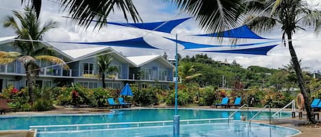 Piscine extérieure, parasols de plage, chaises longues