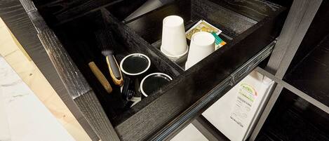 A black tray with a coffee maker, cups, and a menu.