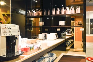 A coffee machine, a toaster, and a shelf with various items. - Minsuku (Taitung)
