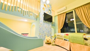 A children's playroom with a slide, a bed, and a TV mounted on the wall. - Minsuku (Taitung)