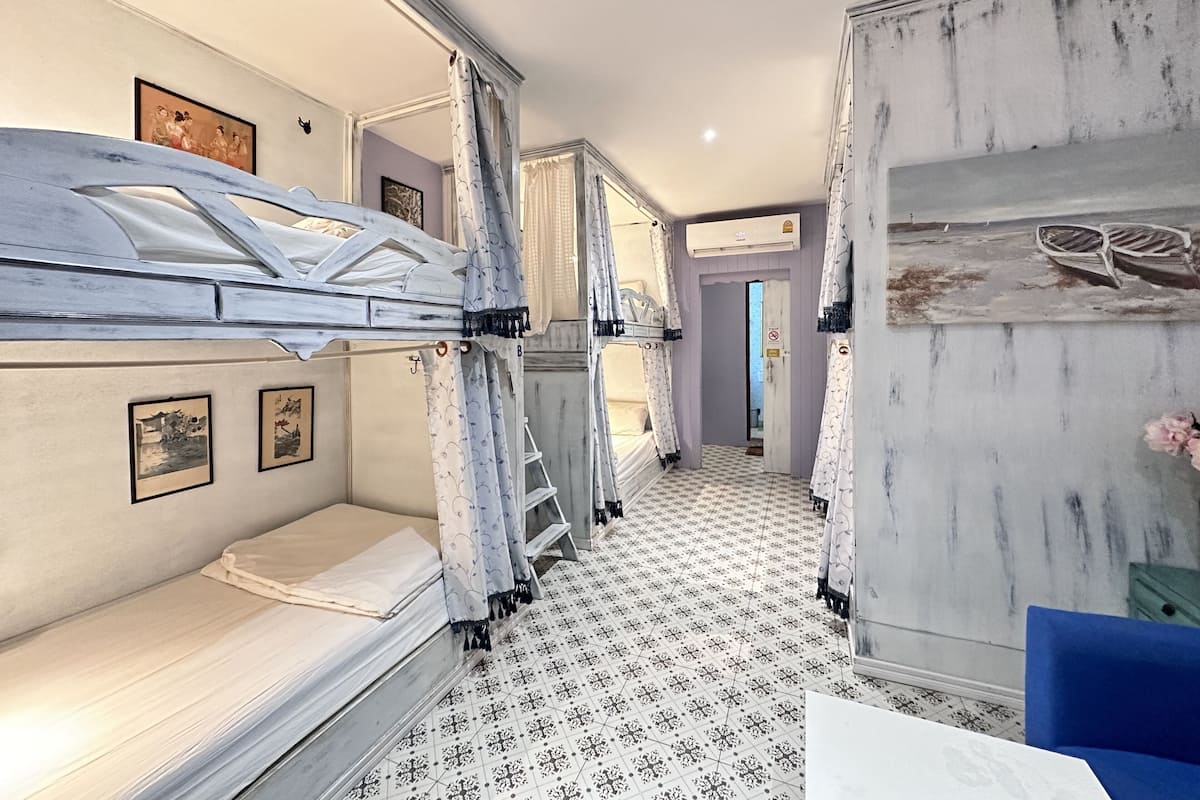 Una habitación con literas, un armario y suelo estampado.