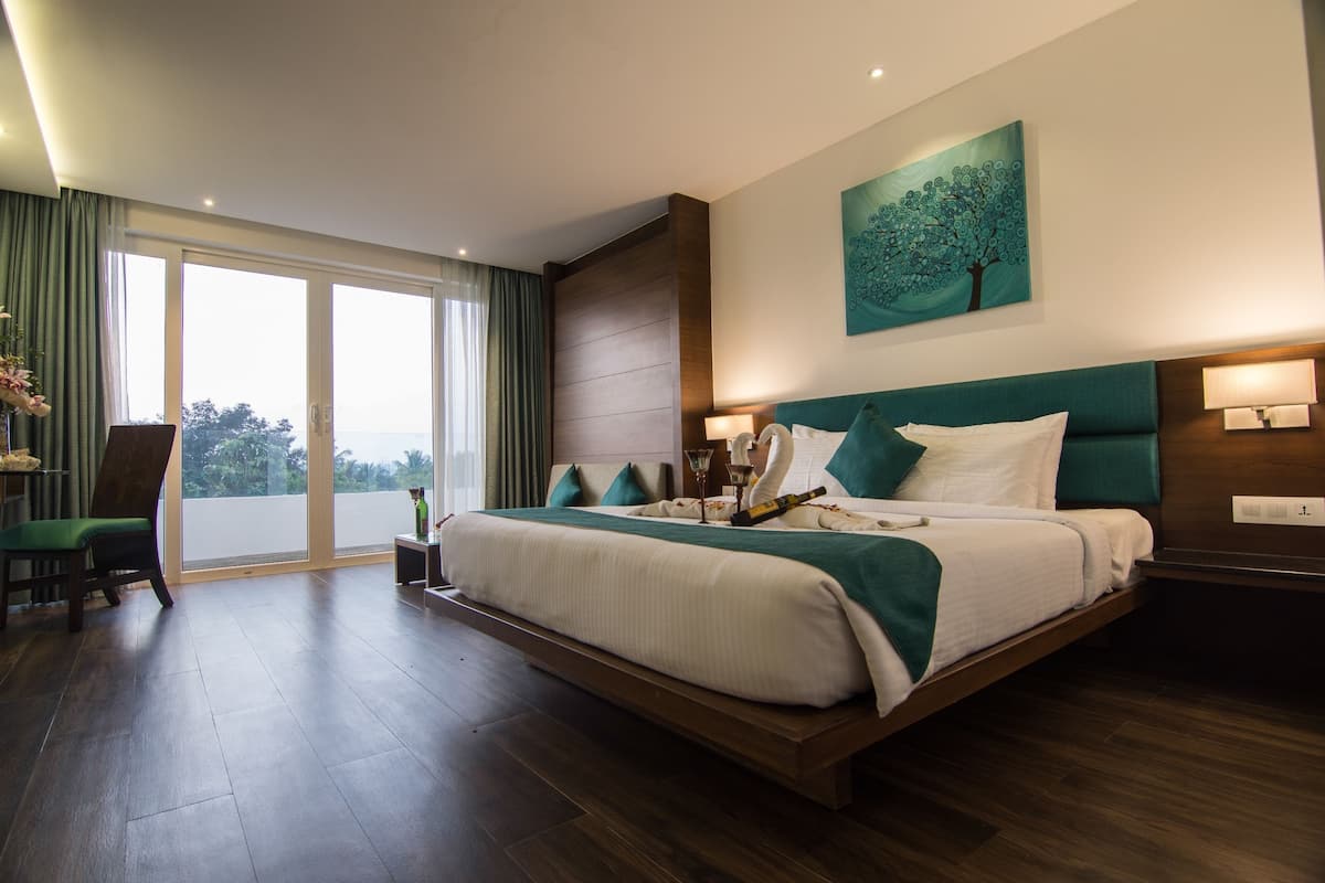 A spacious bedroom with a large bed, a view through the sliding doors, and a modern design.