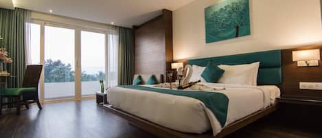 A spacious bedroom with a large bed, a view through the sliding doors, and a modern design.