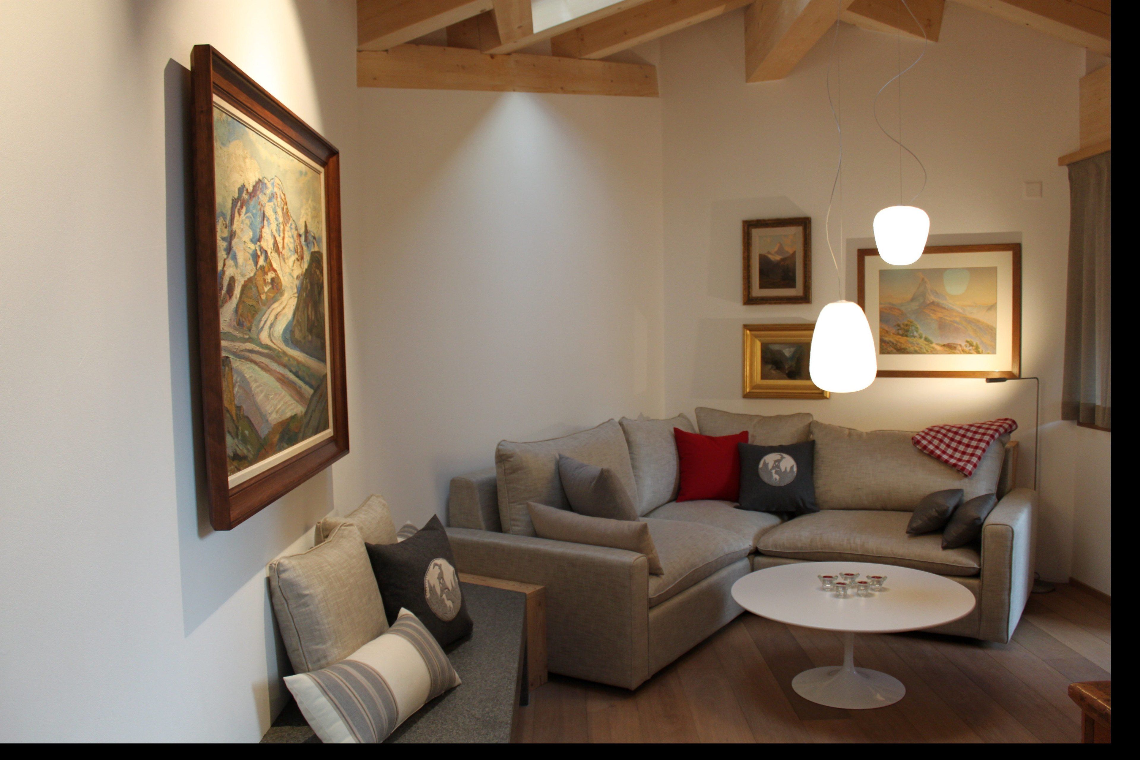 Ein Wohnzimmer mit einer Couch, einem Couchtisch und Kunstwerken an den Wänden.