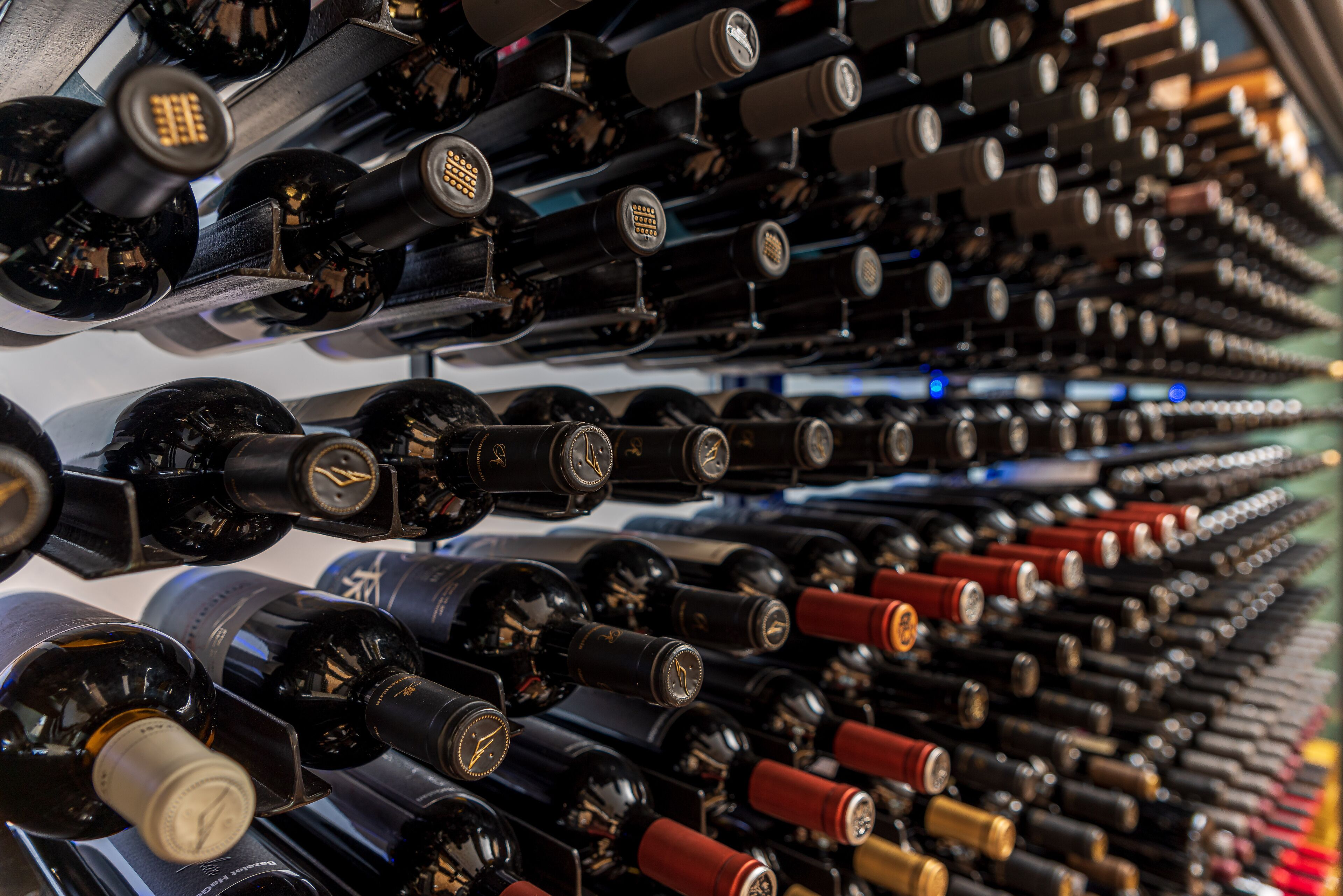 A wine cellar with rows of wine bottles.