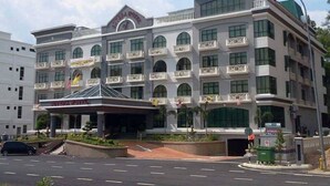 A multi-story hotel with a prominent entrance, balconies, and a green roof. - Sutera Hotel (Seremban)