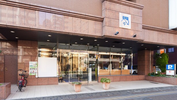 A building with a glass entrance, a sign with Japanese characters, and a bicycle parked outside. - Toyoko Inn Hiroshima-eki Minami-guchi Migi (Hiroshima)