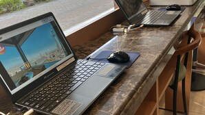 A row of laptops on a marble counter with a view of the street outside. - Toyoko Inn Hiroshima-eki Minami-guchi Migi (Hiroshima)