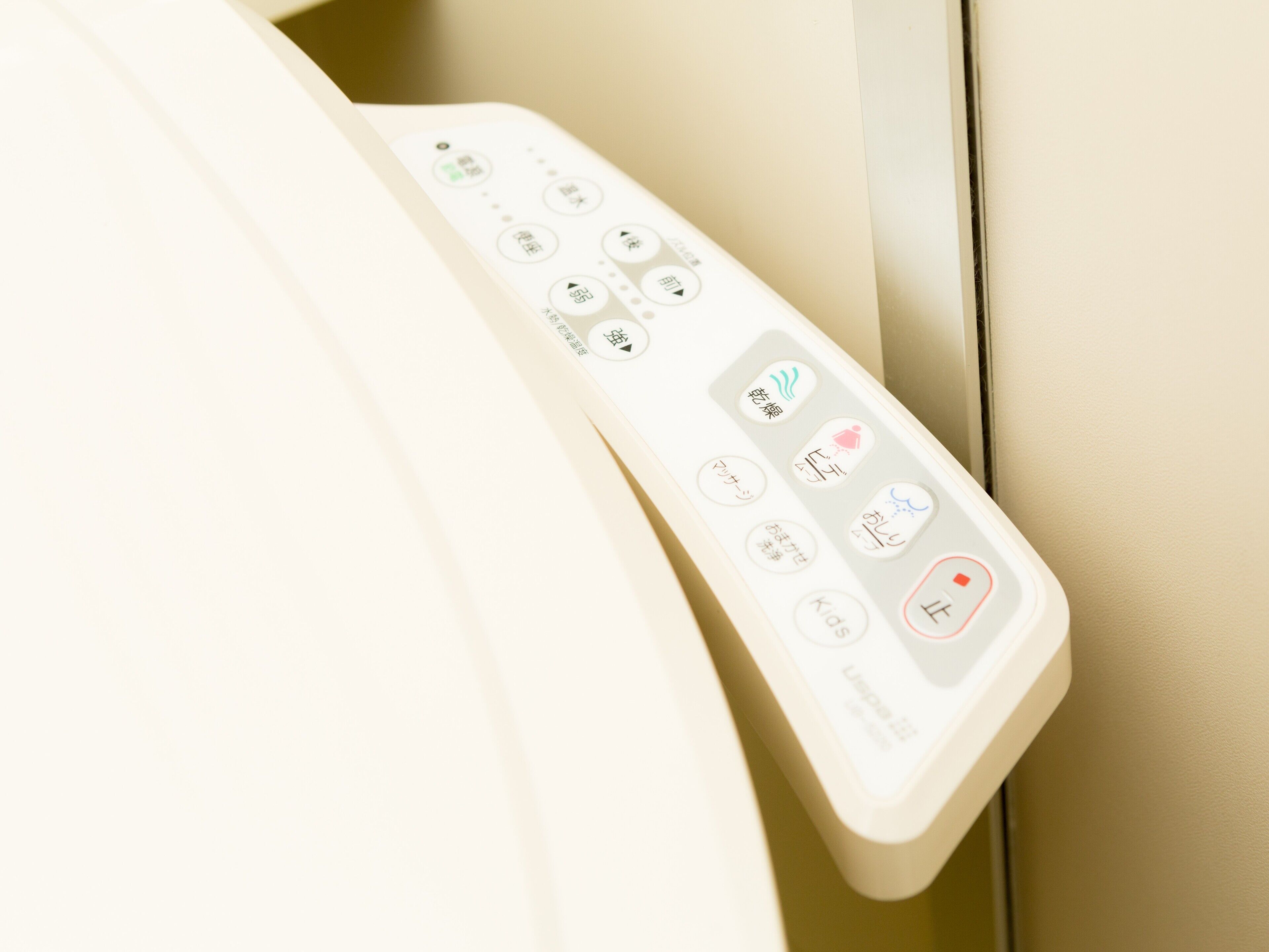 A remote control with multiple buttons, likely for a home automation system.
