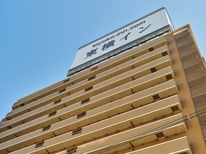 A multi-story hotel with a prominent sign at the top.