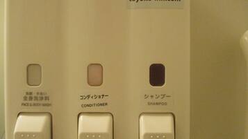 A control panel with buttons for face and body wash, conditioner, and shampoo.
