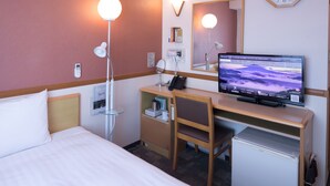 A hotel room with a bed, desk, chair, and a television displaying a scenic wallpaper.