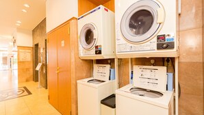 A hotel laundry room with two front-loading washing machines and a dryer. - Toyoko Inn Yonago Ekimae (Yonago)