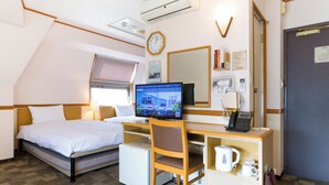 A hotel room with a bed, desk, chair, and a small kitchenette. - Toyoko Inn Kumamoto Ekimae (Kumamoto)
