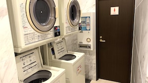 A laundry facility with multiple washing machines, a control panel, and a door marked "Ladies". - Toyoko Inn Tokyo Nihombashi Mitsukoshi Mae A4 (Tokyo)