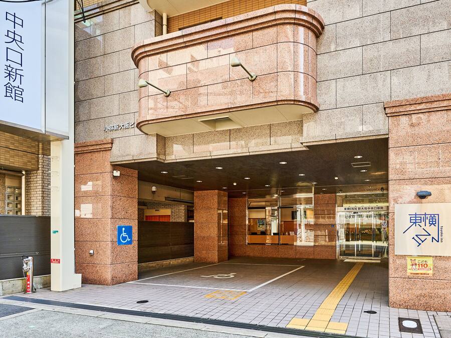 Entrada de hotel con rampa y señal de accesibilidad para personas con discapacidad.