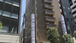 A tall building with multiple balconies and a sign indicating it is a hotel. - Toyoko Inn Tokyo Nihombashi Ningyocho (Tokyo)