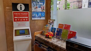 A hotel reception area with a digital information kiosk, travel guides, and a QR code for the Toyoko Inn Club. - Toyoko Inn Tokyo Nihombashi Ningyocho (Tokyo)