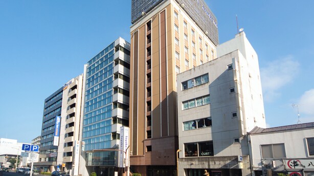 A multi-story hotel with a modern design, featuring a prominent sign at the top and several windows on the facade. - Toyoko Inn Matsue Ekimae (Matsue)