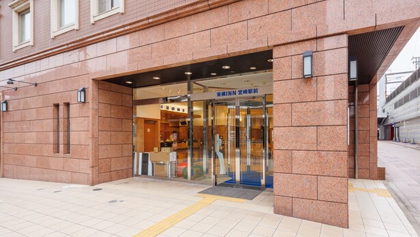 A hotel entrance with a modern design, featuring a glass door and a sign in a foreign language. - Toyoko Inn Miyazaki Ekimae (Miyazaki)