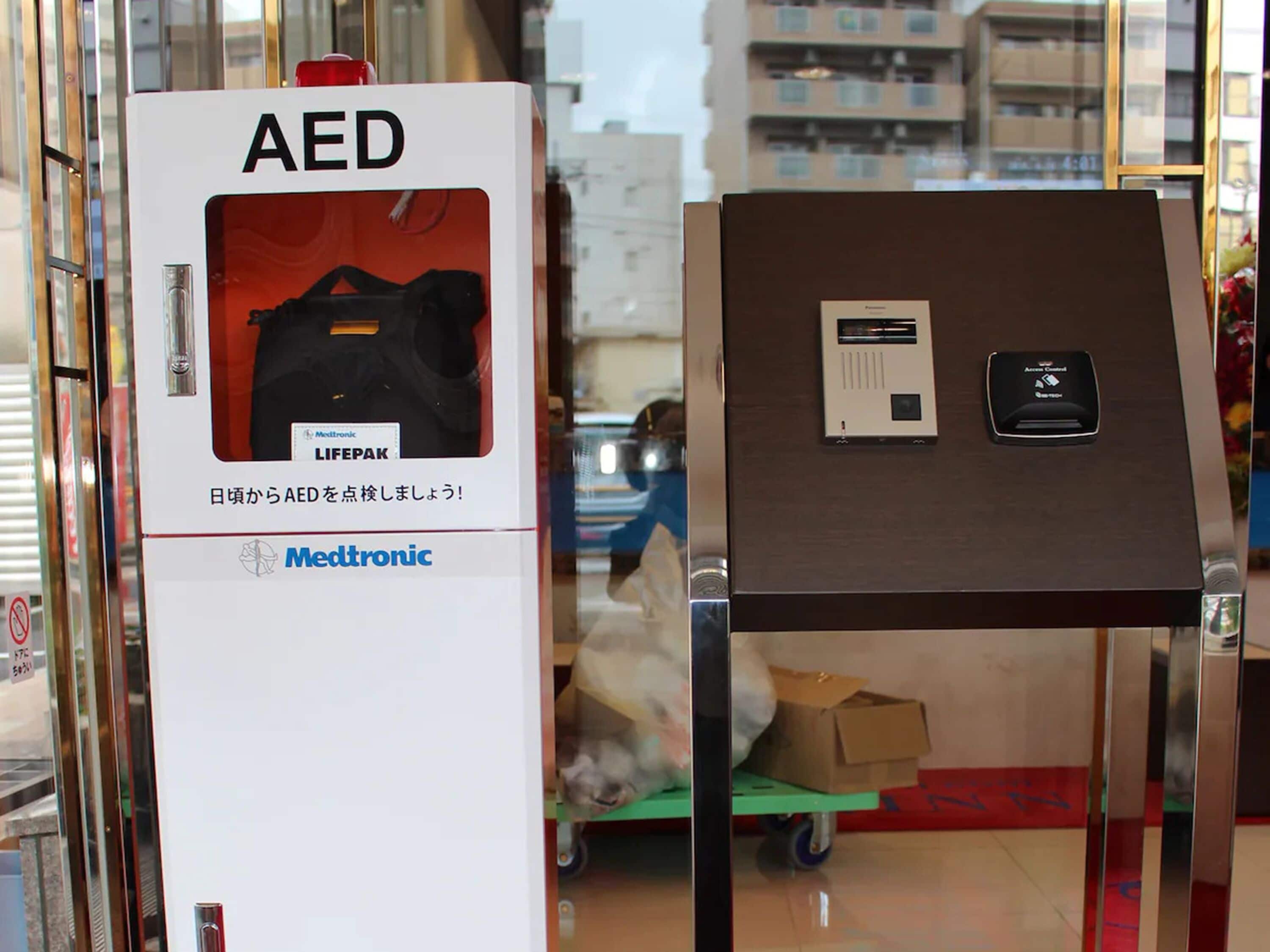 An AED device and a medical control panel on display.