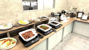 A buffet setup with various dishes and a weighing scale. - Toyoko Inn Kawasaki Station Shiyakusho Dori (Kawasaki)